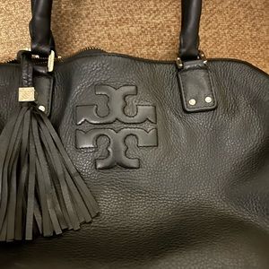 Beautiful leather Tory Burch has a worn mark on the bottom edge & a few scuffs.
